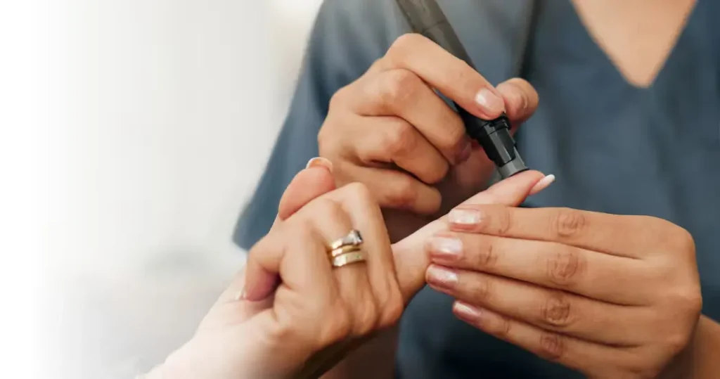 A nurse helps check someone's blood sugar.